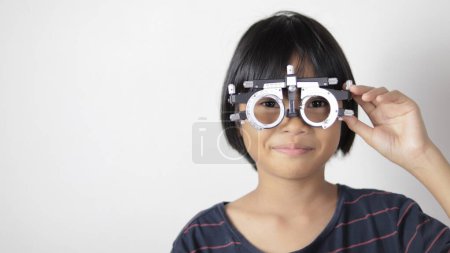 Photo for Child eye exam, kid eye test in optical, kid eye test by Phoropter in hospital - Royalty Free Image
