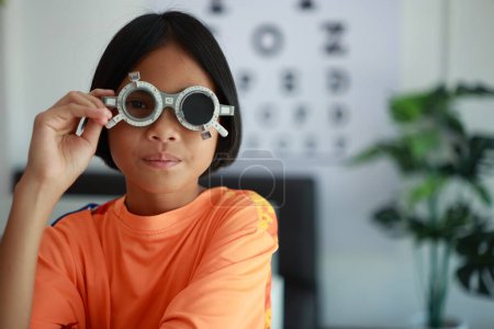 Photo for Child eye exam in optical store, kid eye test - Royalty Free Image
