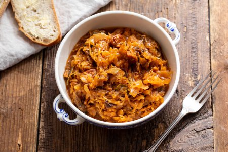 Photo for Traditional polish dish of bigos, cabbage with meat, mushrooms and prunes - Royalty Free Image