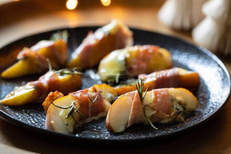 Photo for Christmas canapes made of pears, blue cheese and parma ham - Royalty Free Image
