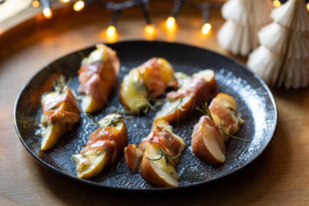 Photo for Christmas canapes made of pears, blue cheese and parma ham - Royalty Free Image
