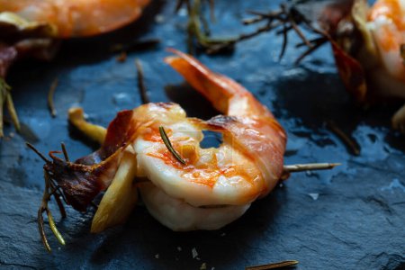 Photo for Rosemary skewers with grilled prawns, mushrooms and parma ham - Royalty Free Image