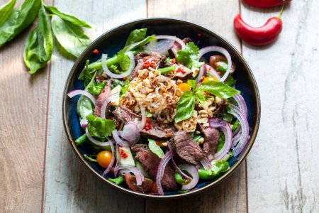 Photo for Thai salad with cucumber, herbs and beef - Royalty Free Image