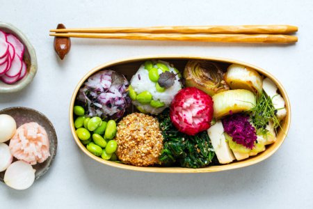 Photo for Japanese lunch with silken tofu, onigiri, spinach gomae, miso leeks ad pickled vegetables - Royalty Free Image