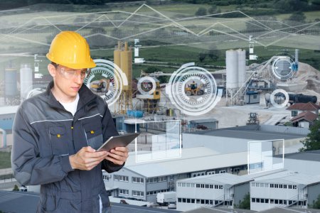 Engineer with digital tablet on a background of modern smart factory. Digital transformation and industry 4.0 