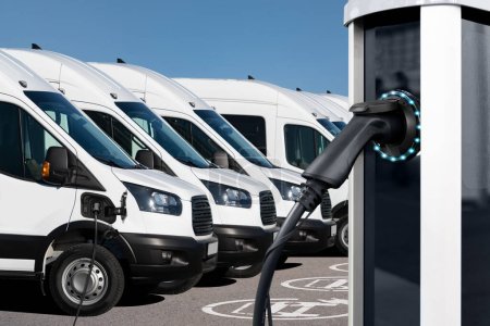 Electric vehicles charging station on a background of a van. Concept