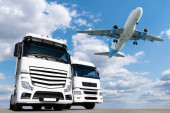 Airplane in the sky above the trucks. World trade and transportation concept Poster #647884400