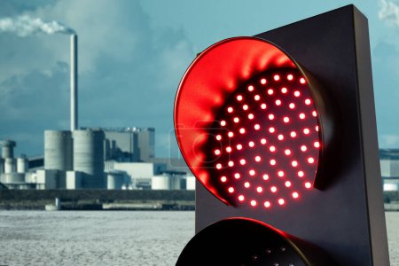 Red traffic light on a background of city after the effects of global warming and air pollution. High quality photo