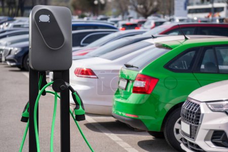 Electric vehicles charging station on a background of a row of cars. Concept..