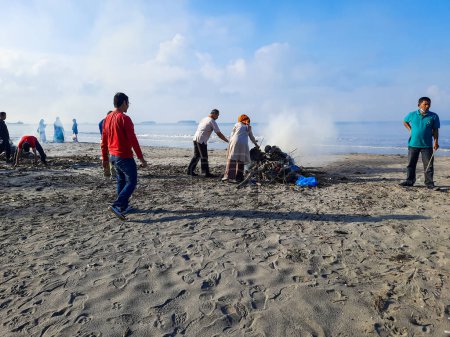 Photo for Pariaman, Indonesia - January 5 2024 : People are cleaning up rubbish in the beach area in Apar Village - Royalty Free Image