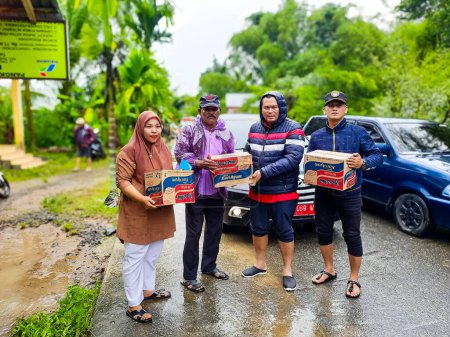 Photo for Pariaman, Indonesia - March 8, 2024 : Mr. Regional Secretary of Pariaman City Hands Over Food Aid to Flood Victims in North Pariaman District - Royalty Free Image