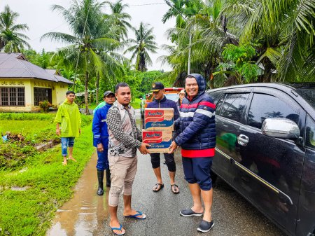 Photo for Pariaman, Indonesia - March 8, 2024 : Mr. Regional Secretary of Pariaman City Hands Over Food Aid to Flood Victims in North Pariaman District - Royalty Free Image