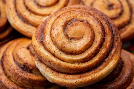 Photo for Delicious homemade cinnamon buns. Close-up photo of cinnamon bread still warm after baking - Royalty Free Image