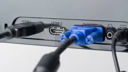 Foto de Cables HDMI y VGA conectados al monitor. Un puerto HDMI más es gratuito. Cableado Pover está conectado en el monitor - Imagen libre de derechos