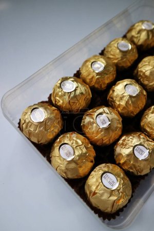 Photo for A group of chocolate with white background in selective focus. Ferrero Rocher is a chocolate sweet made by Italian Ferrero Spa. - Royalty Free Image