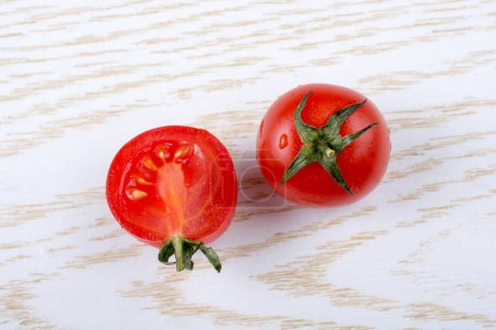 Photo for Red ripe tasty fresh cherry tomatos cut in halves - Royalty Free Image