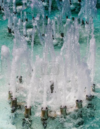 Photo for The fountains gushing sparkling water in a pool in a park - Royalty Free Image