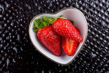 Photo for Juicy, sweet and ripe strawberry fruit in a bowl - Royalty Free Image