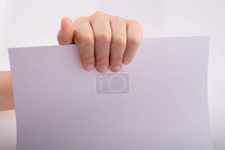 Photo for Hand holding a white sheet of paper on a white background - Royalty Free Image