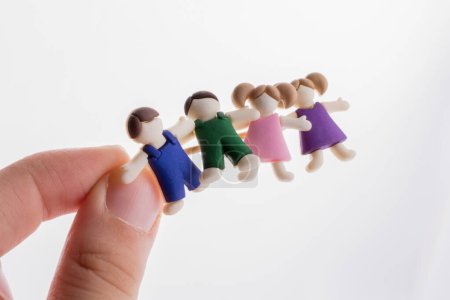 Foto de Pequeños niños y niñas coloridos figuritas de niños en la mano - Imagen libre de derechos