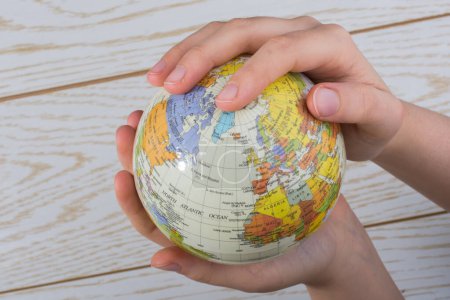 Photo for Hand holding a globe  with map on it - Royalty Free Image