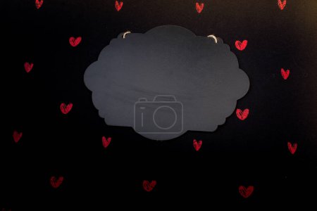 Photo for Black notice board  and red hearts on black background - Royalty Free Image