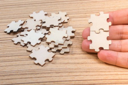 Photo for Man holding last piece of jigsaw puzzle as business strategy concept - Royalty Free Image