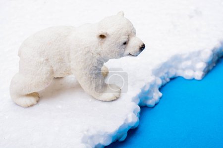 Photo for Fake Polar bear cub placed on fake snow and sea  background environment - Royalty Free Image