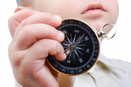 Photo for Isolated compass in baby's hand  on a white background - Royalty Free Image