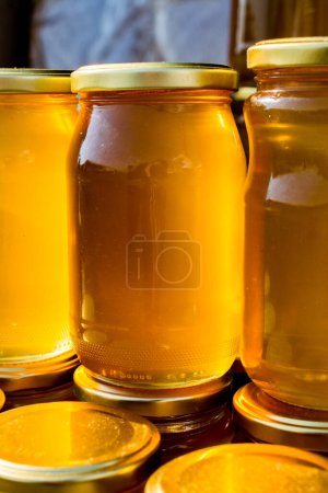 Photo for Glass jar of full of fresh honey with lid - Royalty Free Image
