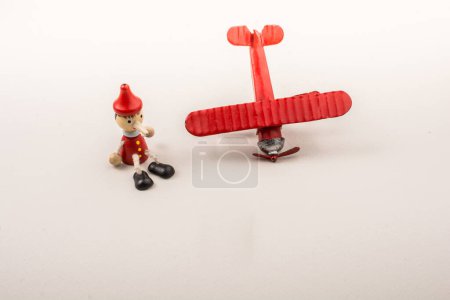 Photo for Airplane, Bullet and wooden pinocchio with his long nose - Royalty Free Image