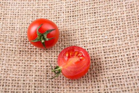 Photo for Red ripe tasty fresh cherry tomatos cut in halves - Royalty Free Image