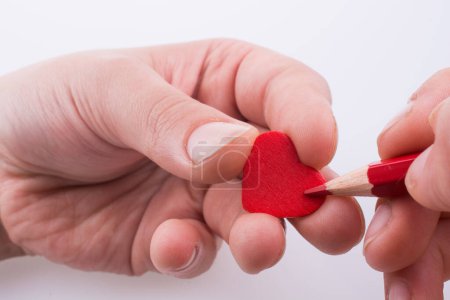 Photo for Pencil pointing a red heart - Royalty Free Image