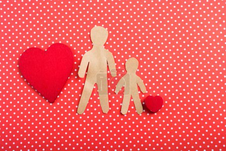 Photo for Heart and man and child shape cut out of paper - Royalty Free Image