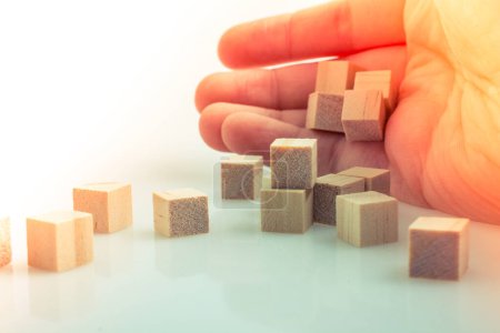 Photo for Hand playing with wooden cubes as  educational and business concept - Royalty Free Image