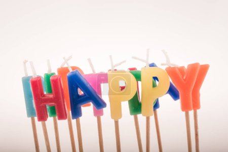 Photo for Color candles on sticks write the word happy - Royalty Free Image