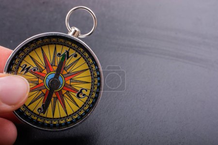 Photo for Compass in hand  as symbol of tourism and outdoor activities with compass - Royalty Free Image