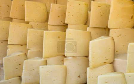 Photo for Cuts of kashkaval or kasseri  cheese for sale on the shelf - Royalty Free Image