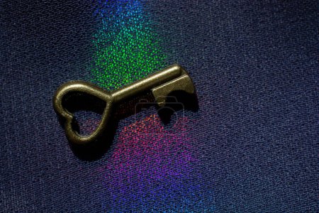 Photo for Vintage key. .Antique key. Retro key on colorful fabric background - Royalty Free Image