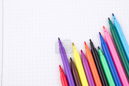 Photo for Colorful felt-tip pens on a notebook - Royalty Free Image