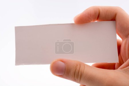 Photo for Hand holding a note paper on a white background - Royalty Free Image