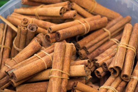 Photo for Bunches of cinnamon sticks in the herbal shop - Royalty Free Image