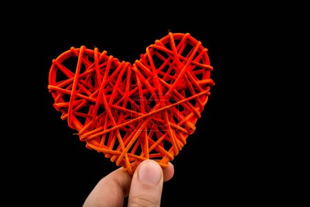 Photo for Handmade straw heart or valentines day object in hand - Royalty Free Image