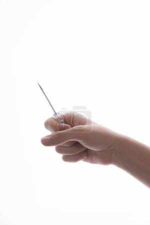 Photo for Hand holding a circuit tester screwdriver on a white background - Royalty Free Image