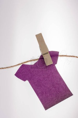 Foto de Ropa de papel cuelga de una cuerda con la ayuda de pinzas de ropa - Imagen libre de derechos