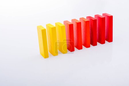 Photo for Colorful Domino Blocks in a line on a white background - Royalty Free Image