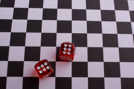 Photo for Red Dice  on a checked background - Royalty Free Image