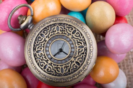 Photo for Mechanical pocket watch on colorful candy sweets - Royalty Free Image