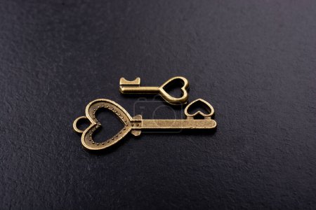 Photo for Heart shaped retro metal keys on dark background - Royalty Free Image