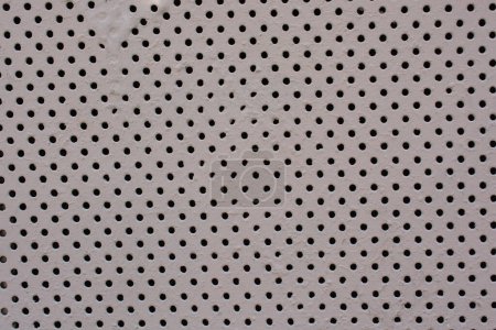 Detailed texture background gray sheet metal perforated. Steel plate with holes